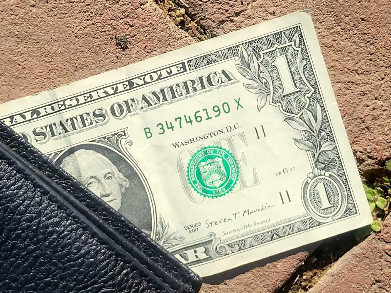 A dollar bill animated to show the serial number changing